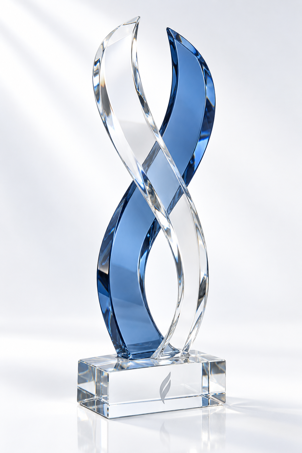 Sculptural award with intersecting clear and smoky-blue glass ribbons